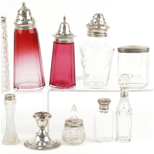 131 - Victorian and later silver mounted glassware including cranberry glass casters, scent bottles and si... 