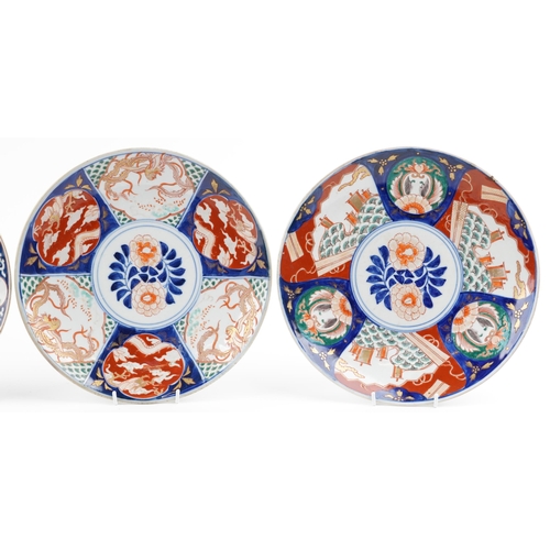 1204 - Four Japanese porcelain chargers including a pair hand painted with figures and panels of flowers, t... 