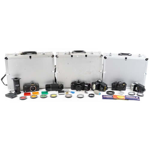 1334 - Cameras and accessories in fitted cases including Canon A1W/50mm lens and Canon T70