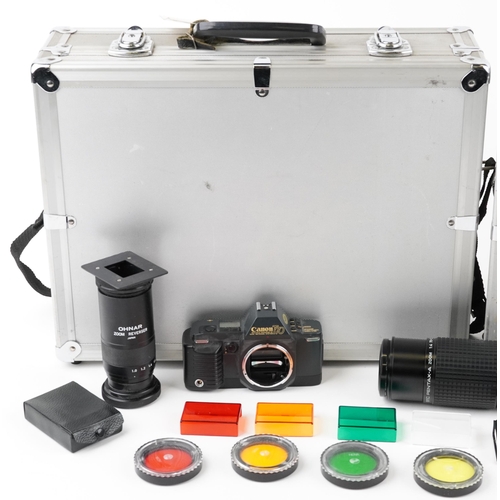 1334 - Cameras and accessories in fitted cases including Canon A1W/50mm lens and Canon T70