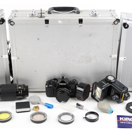 1334 - Cameras and accessories in fitted cases including Canon A1W/50mm lens and Canon T70