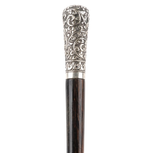 333 - Exotic wood walking stick with unmarked silver pommel embossed with flowers, 92cm in length