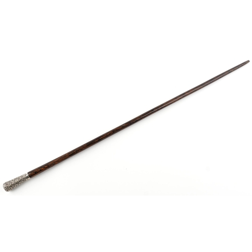 333 - Exotic wood walking stick with unmarked silver pommel embossed with flowers, 92cm in length