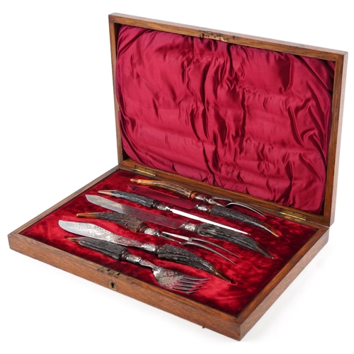 228A - Victorian seven piece staghorn handled carving set with silver mounts housed in a Henry Wigful silk ... 