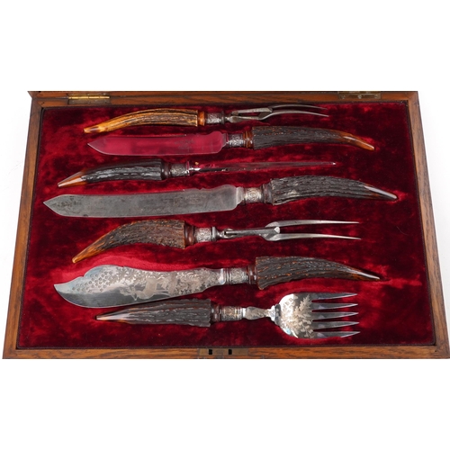 228A - Victorian seven piece staghorn handled carving set with silver mounts housed in a Henry Wigful silk ... 