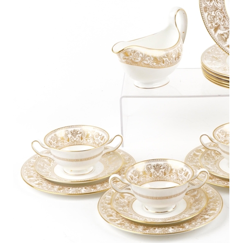 396 - Wedgwood gold Florentine dinnerware including gravy boat and dinner plates, the largest each 27cm in... 