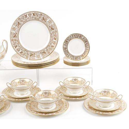 396 - Wedgwood gold Florentine dinnerware including gravy boat and dinner plates, the largest each 27cm in... 