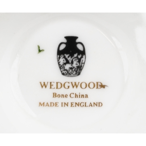 396 - Wedgwood gold Florentine dinnerware including gravy boat and dinner plates, the largest each 27cm in... 