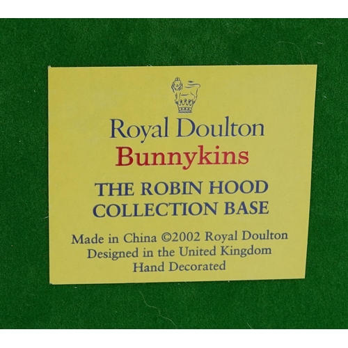 373 - Set of eight Royal Doulton Bunnykins figures from the Robin Hood Collection with display stand compr... 