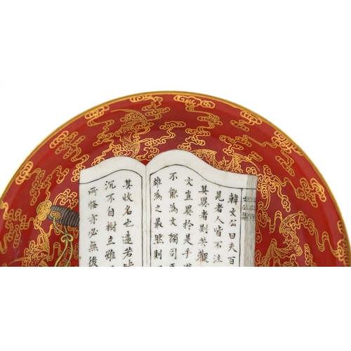 216 - Chinese porcelain iron red ground dish hand painted and gilded with a censer and book of calligraphy... 