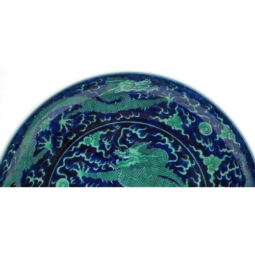 119 - Large Chinese porcelain blue ground charger hand painted with dragons chasing the flaming pearl amon... 