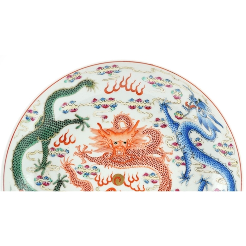 117A - Chinese porcelain shallow dish hand painted in the famille rose palette with dragons chasing the fla... 