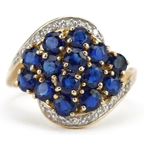 2080 - 9ct gold blue spinel and diamond cluster crossover ring, size J, 2.8g