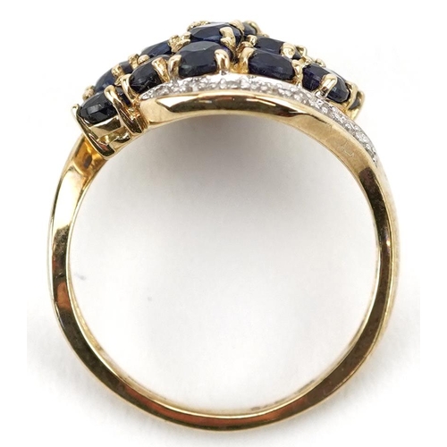 2080 - 9ct gold blue spinel and diamond cluster crossover ring, size J, 2.8g