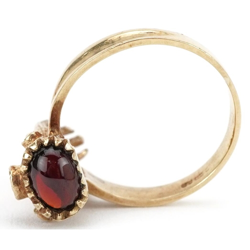 2027 - 9ct gold female's hand ring set with a cabochon garnet, opal and rubies, size N, 4.5g