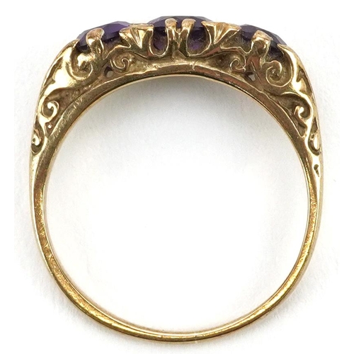 2573 - 9ct gold amethyst three stone ring with ornate scrolled setting, size L, 2.0g