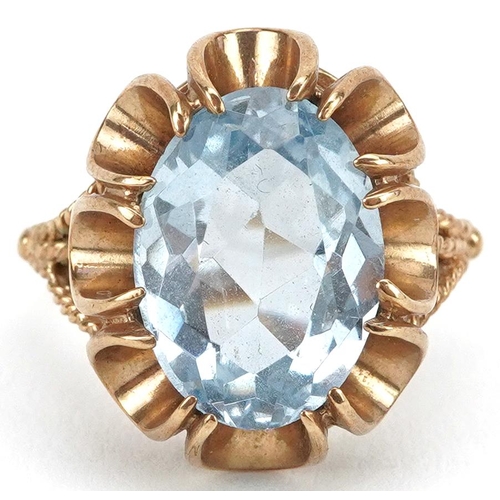 2583 - 9ct gold blue topaz solitaire ring with pierced flower head setting, the topaz approximately 13.75mm... 