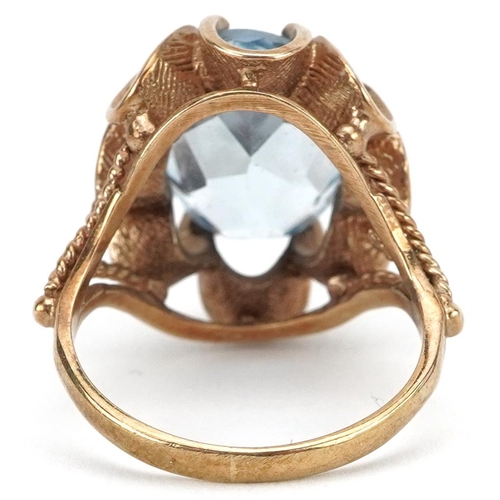 2583 - 9ct gold blue topaz solitaire ring with pierced flower head setting, the topaz approximately 13.75mm... 