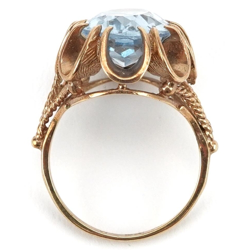 2583 - 9ct gold blue topaz solitaire ring with pierced flower head setting, the topaz approximately 13.75mm... 