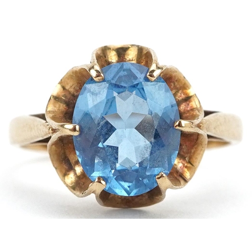 2148 - 9ct gold blue topaz solitaire ring with pierced flower head setting, the topaz approximately 10.0mm ... 