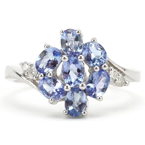 2195 - 14ct white gold tanzanite and diamond flower head crossover ring, size L, 2.8g