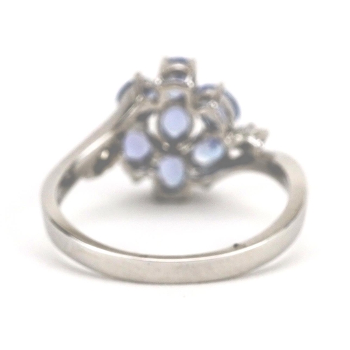 2195 - 14ct white gold tanzanite and diamond flower head crossover ring, size L, 2.8g