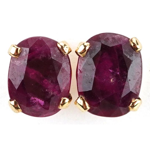 2587 - Pair of unmarked gold ruby solitaire stud earrings, tests as 9ct gold, the rubies each approximately... 