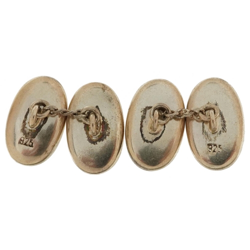 2134 - Pair of silver and enamel fisherman cufflinks, 2.4cm in length, 8.7g