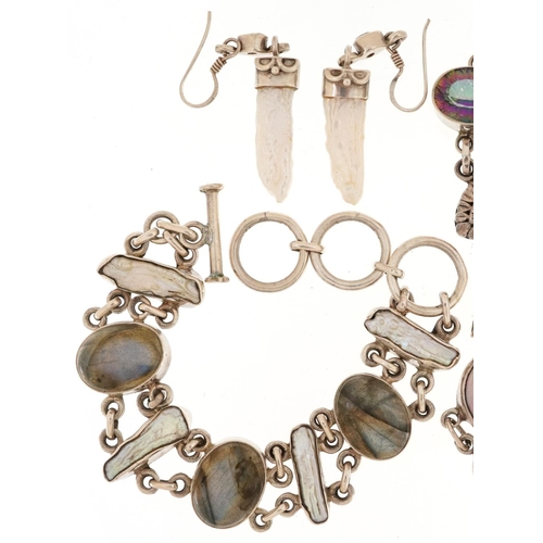 2714 - Silver semi precious stone jewellery comprising four bracelets and a pair of earrings, 102.0g