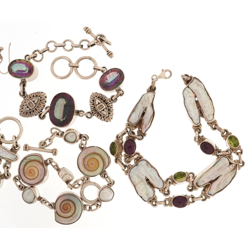 2714 - Silver semi precious stone jewellery comprising four bracelets and a pair of earrings, 102.0g