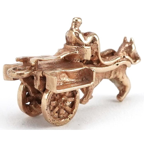 2068 - 9ct gold horse-drawn cart charm with rotating wheels, 2.4cm wide, 3.2g