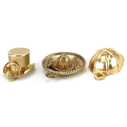 2704 - Three hat charms comprising 9ct gold jockey cap, unmarked gold top hat and yellow metal Mexican somb... 