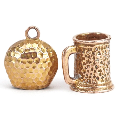 2689 - Two gold charms comprising 9ct gold tankard and unmarked gold cattle bell, the largest 11mm high, to... 