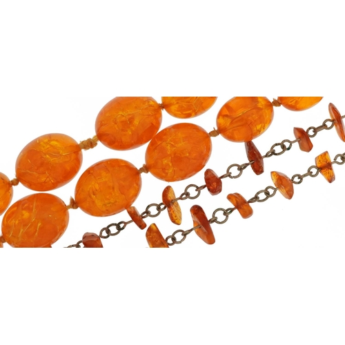 2621 - Two amber coloured necklaces including a two strand graduated bead example, the largest bead 2.1cm w... 