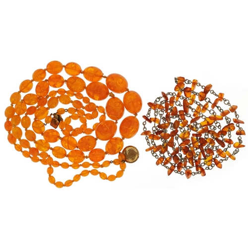 2621 - Two amber coloured necklaces including a two strand graduated bead example, the largest bead 2.1cm w... 