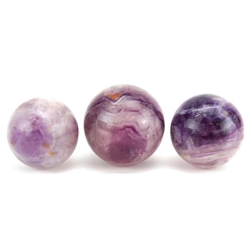 245 - Three polished fluorite spheres, the largest 6.5cm in diameter