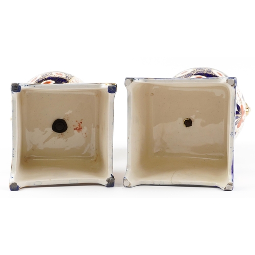 1243 - Large pair of Imari pattern pottery vases and covers with figural handles, each 61.5cm high