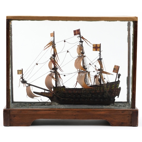 491 - Hand painted wooden model of a rigged battleship housed in a glazed display case, 43cm H x 51cm W x ... 