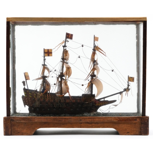 491 - Hand painted wooden model of a rigged battleship housed in a glazed display case, 43cm H x 51cm W x ... 