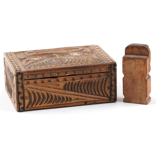 327 - New Zealand Maori carvings including a rectangular box with hinged lid and abalone inlay, the larges... 