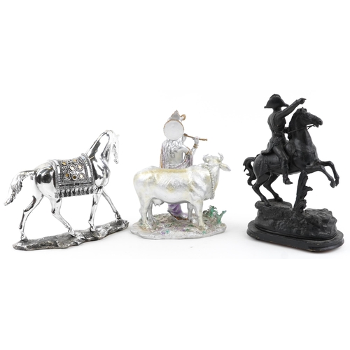 1293 - Three horse sculptures including a patinated spelter example of a soldier on horseback, the largest ... 