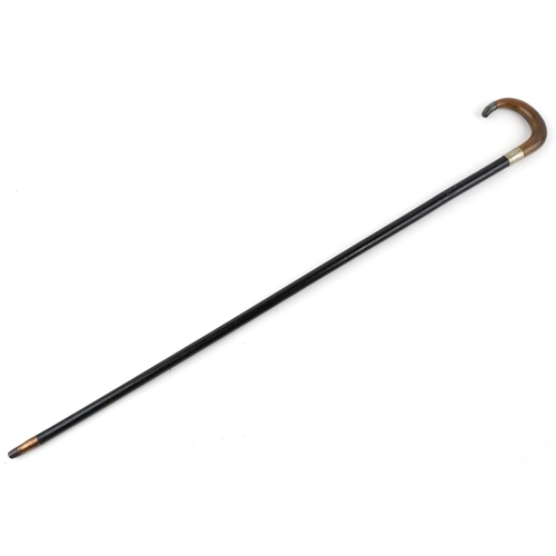 331 - Ebonised walking stick with horn handle and silver mount, the horn handle possibly rhinoceros, 85cm ... 