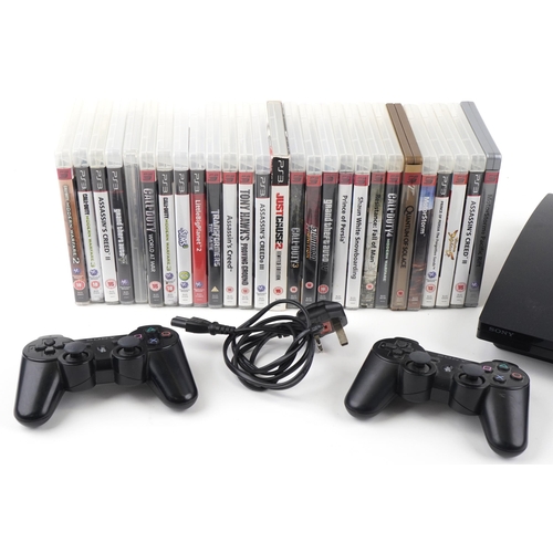 1395 - Sony PlayStation 3 games console with two controllers and a collection of games