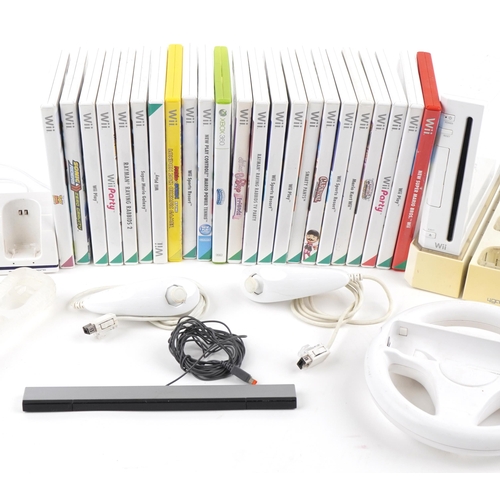 1399 - Two Nintendo Wii games consoles including Wii Mini, with controllers, accessories and a collection o... 