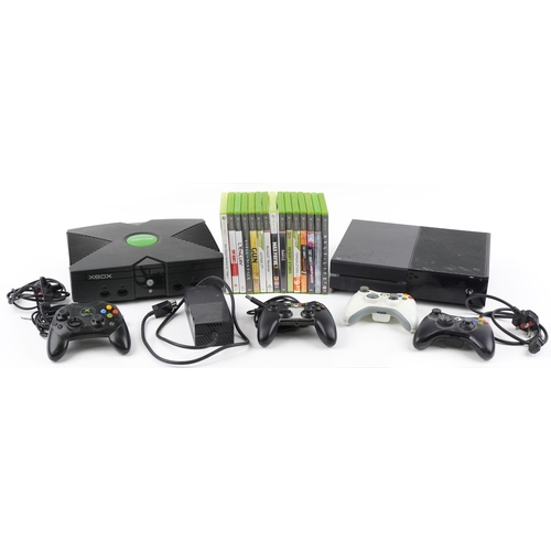 1396 - Xbox One and Xbox games consoles with four controllers and a collection of games