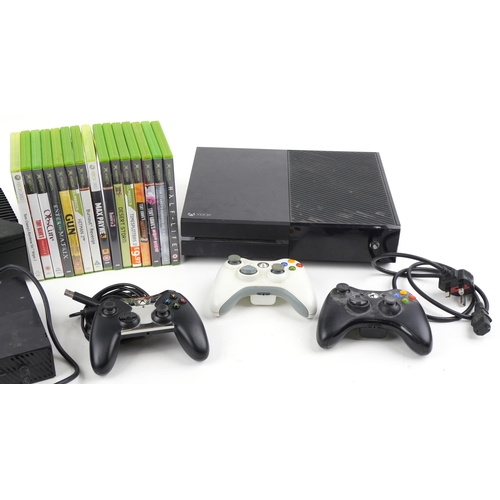 1396 - Xbox One and Xbox games consoles with four controllers and a collection of games