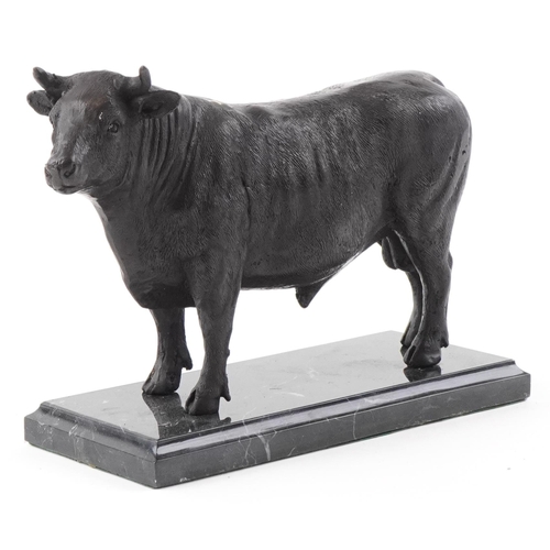 249 - Patinated bronze study of a bull raised on a black marble base, 24cm in length