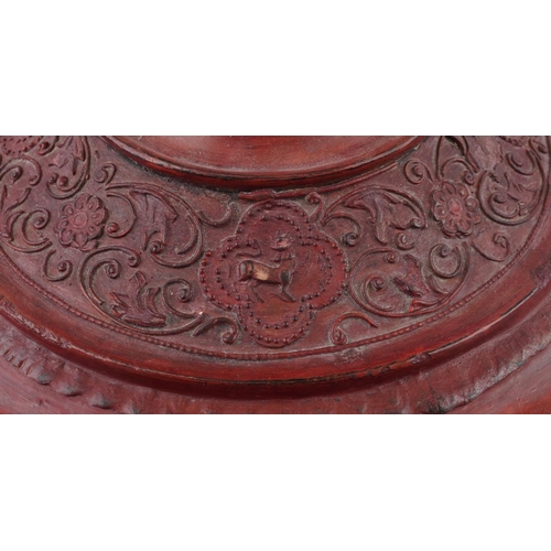 1015A - Large Burmese red painted lacquered box and cover carved with mythical animals amongst flowers, 65.5... 