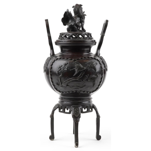 1102 - Large Japanese patinated bronze four footed incense burner and cover with twin handles cast in relie... 