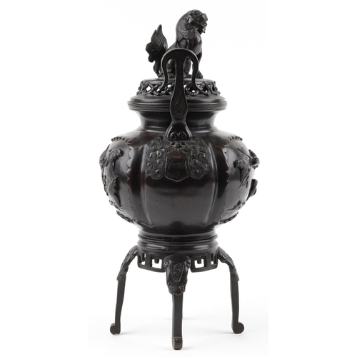 1102 - Large Japanese patinated bronze four footed incense burner and cover with twin handles cast in relie... 